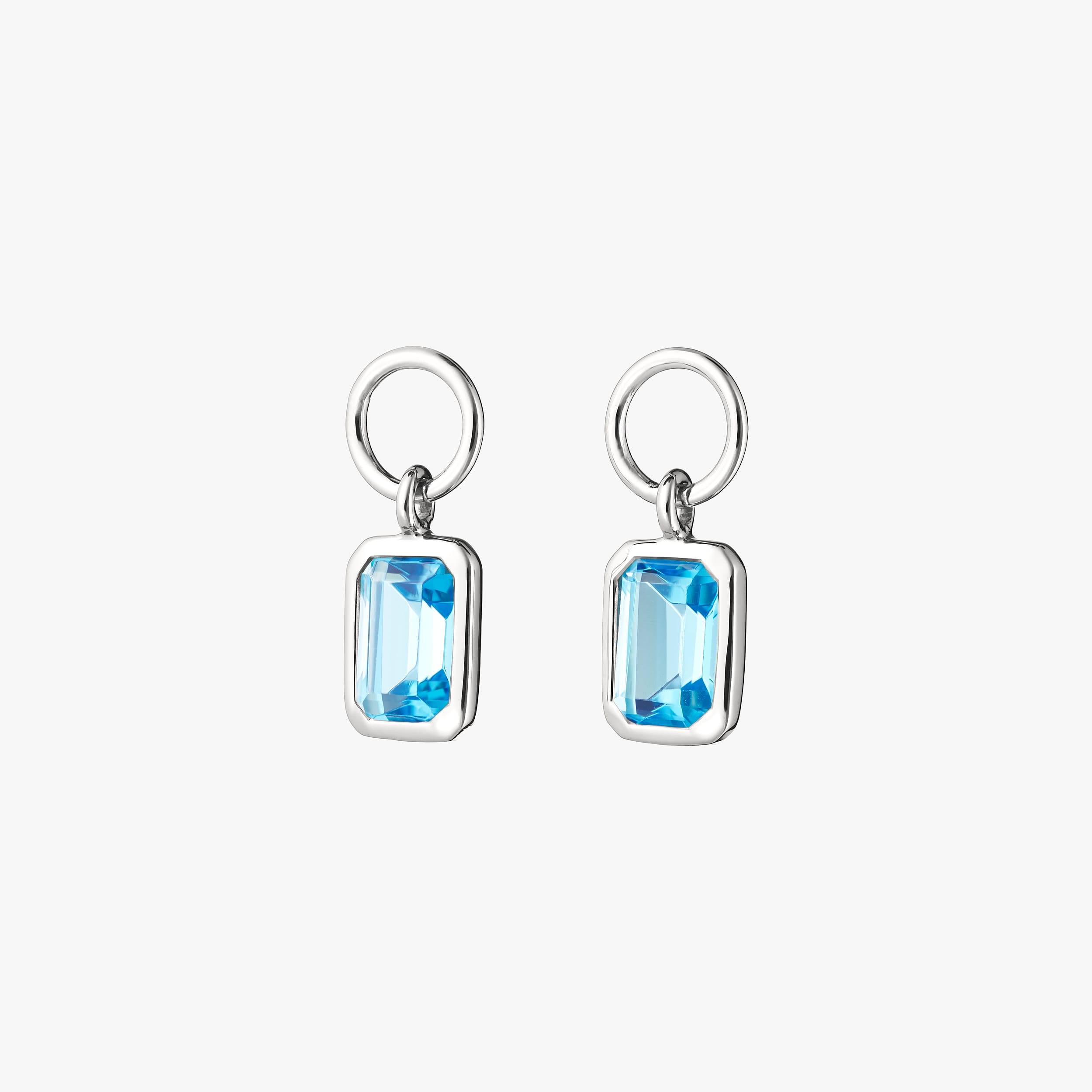 Pair of December's birthstone blue topaz gemstone charms. The perfect gift for those celebrating birthdays in December. Customisable to be added to a pair of huggie hoops, necklace or bracelet.