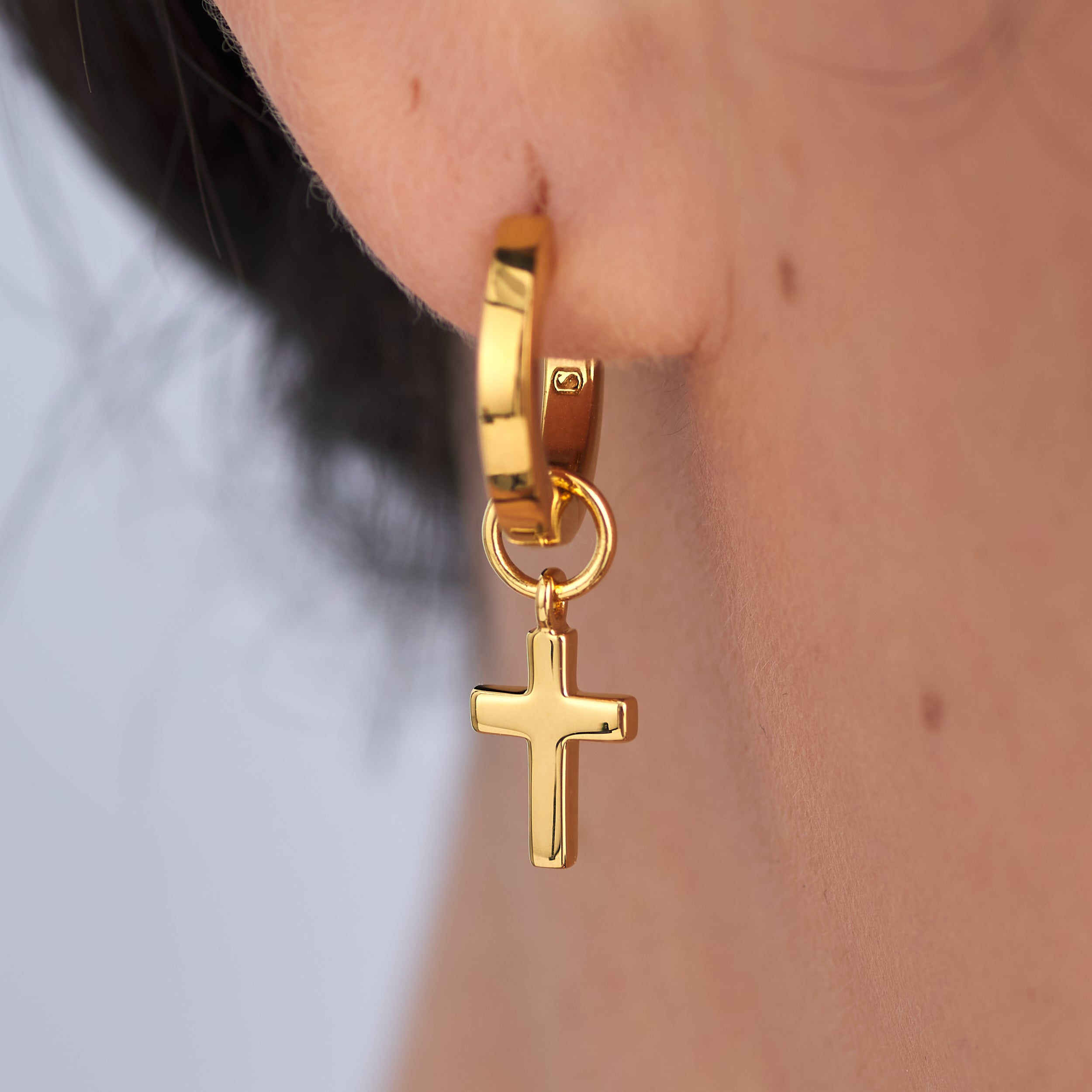 A timeless, high-end finish without the high-end price tag on these 18k gold vermeil huggie hoop earrings with detachable faith inspired cross charms.