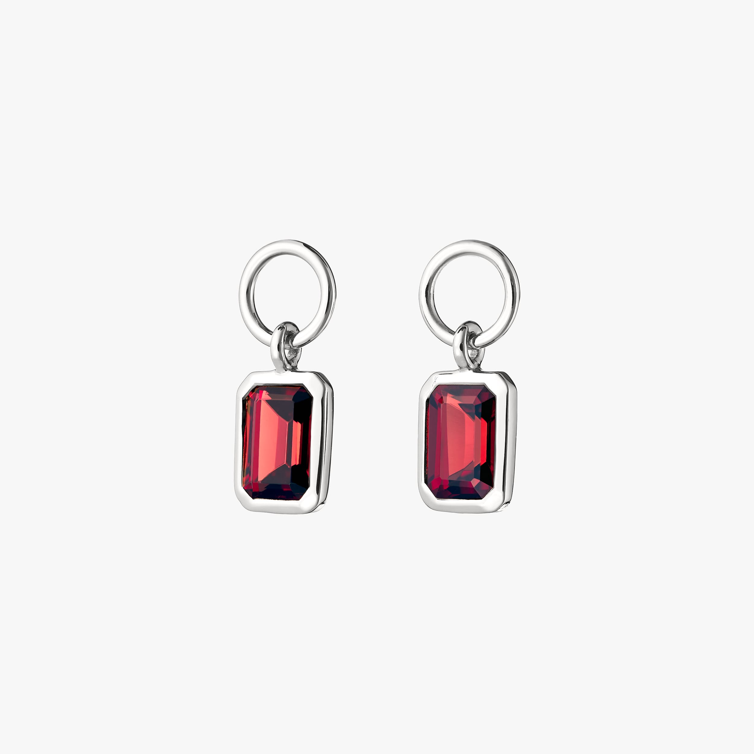 A pair of fiery red garnet gemstone charms encased in premium 925 sterling silver. Perfect to add to huggie hoop earrings, necklaces and bracelets.