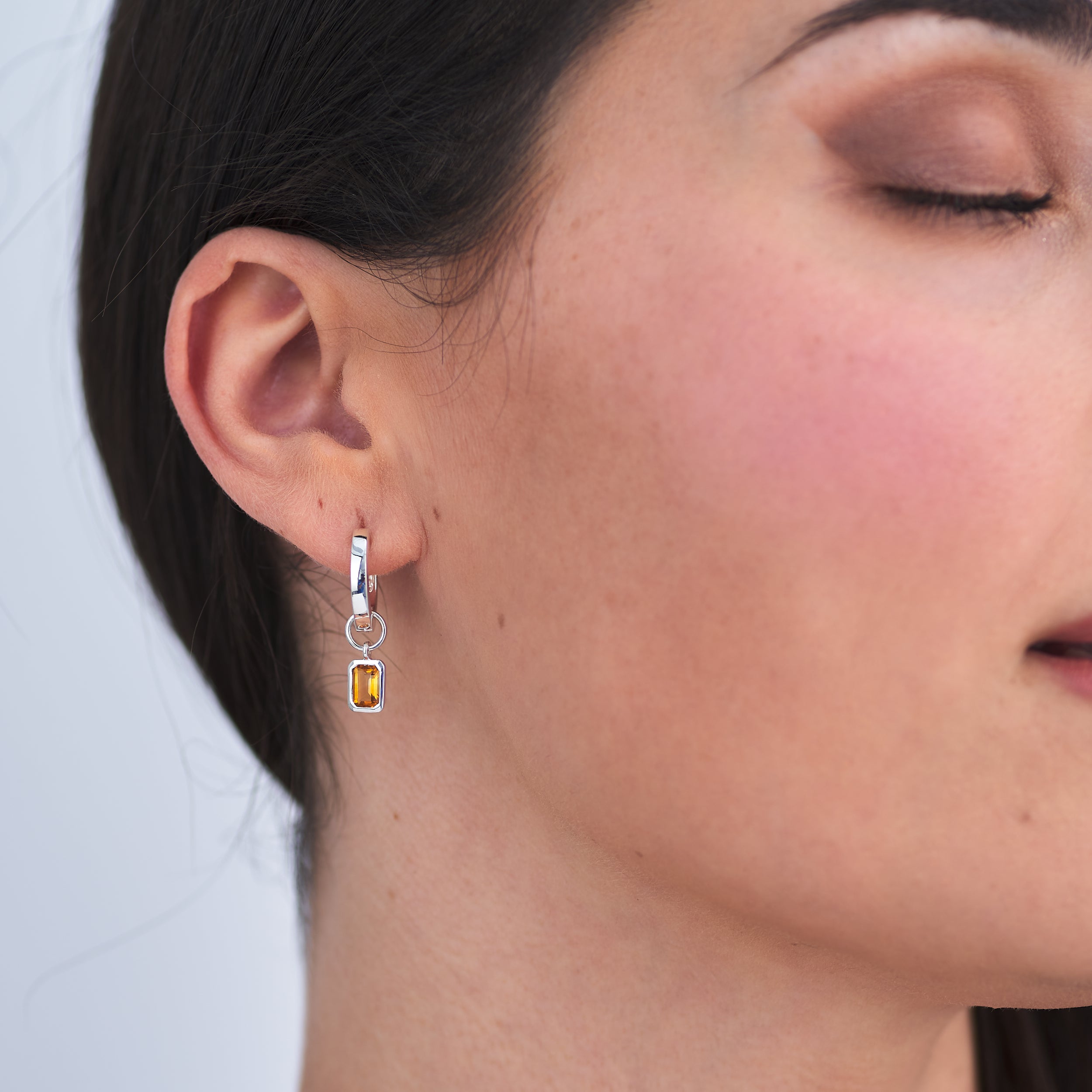 Nickel-free and hypoallergenic jewellery made from Sterling Silver Huggie hoop earrings perfect for sensitive skin with a vivid golden citrine gemstone charm attached.