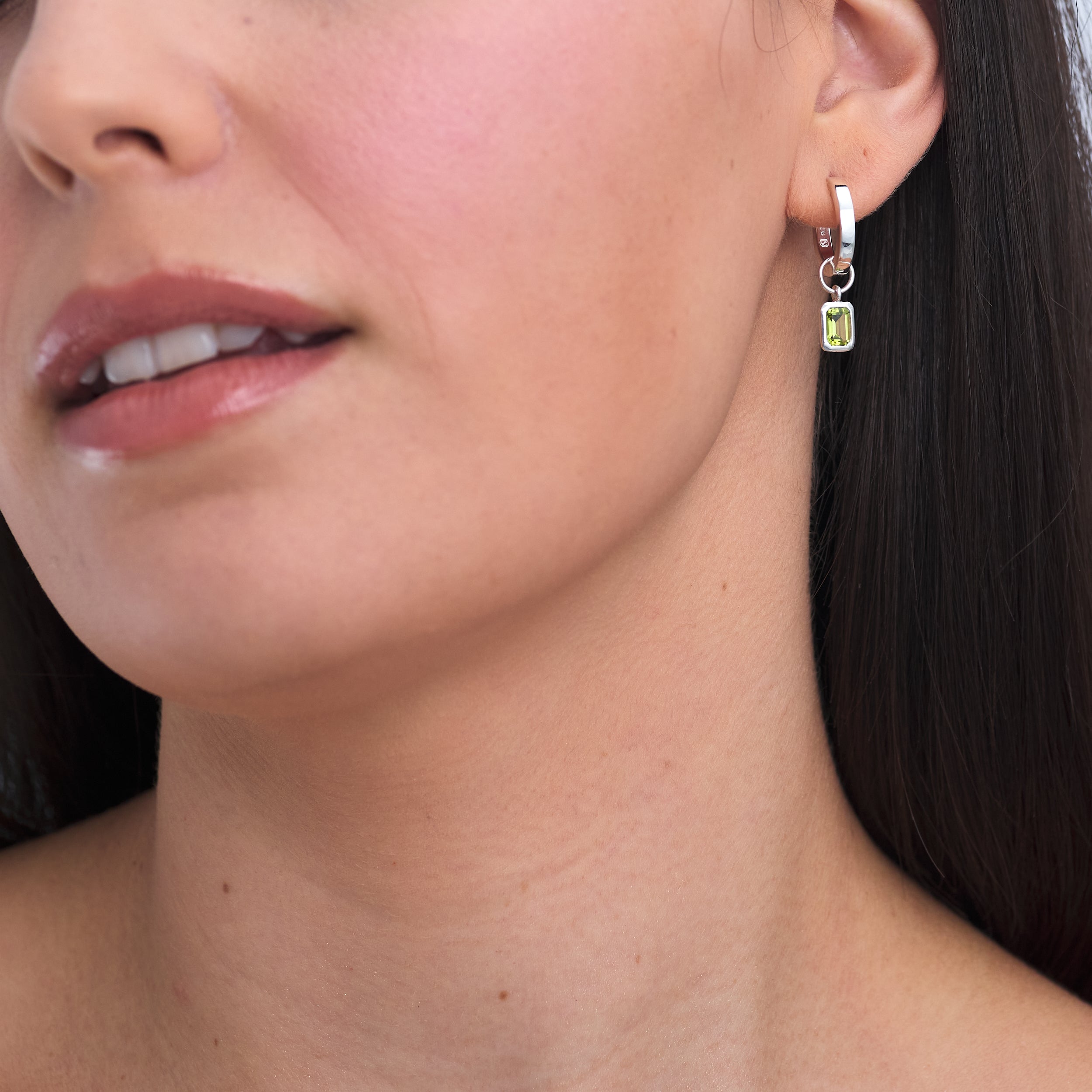 Timeless Classic Sterling Silver Huggie Hoop earring with interchangeable Peridot gemstone charm attached.