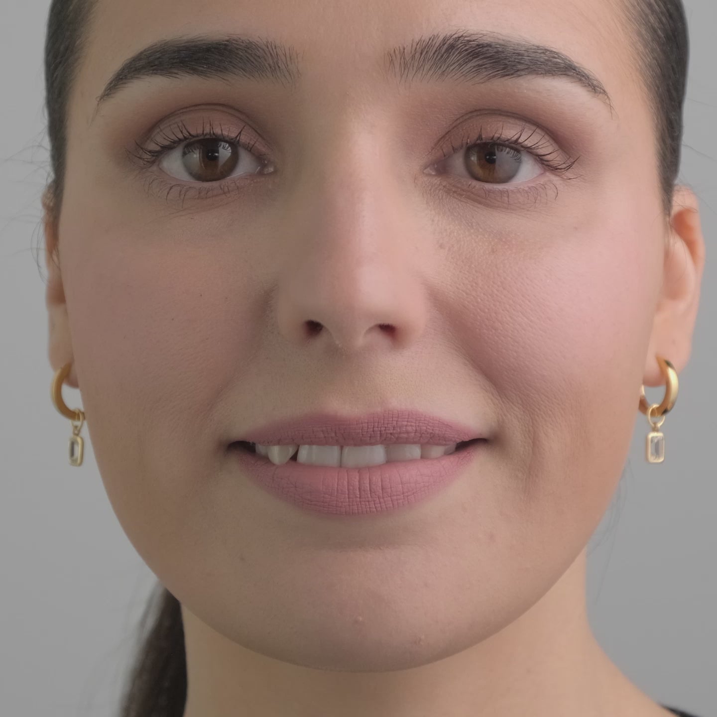 Video of a woman wearing 18k Gold Vermeil earrings with white topaz gemstone charms.