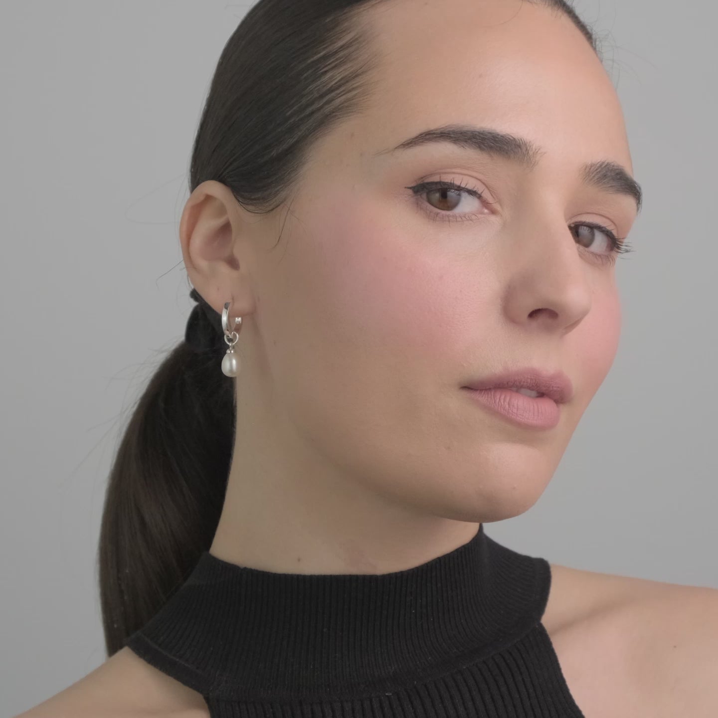 Video of Sterling silver huggie hoop earring with pearl charm attached perfect for that elegant touch to any wedding accessory or gift.