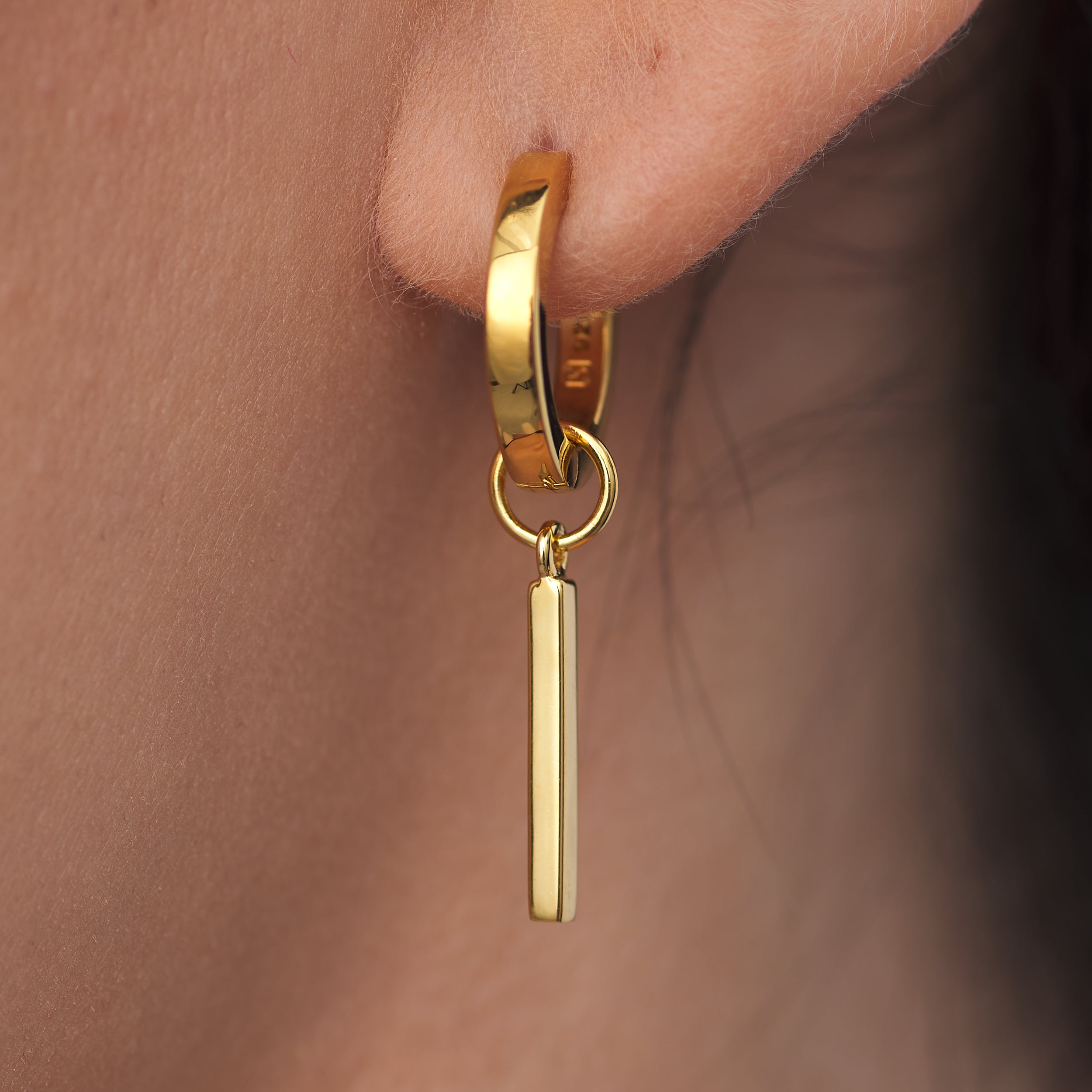 Get the look and feel of solid gold at a fraction of the price with these 18k Gold Vermeil Huggie Hoop earrings with interchangeable charms.