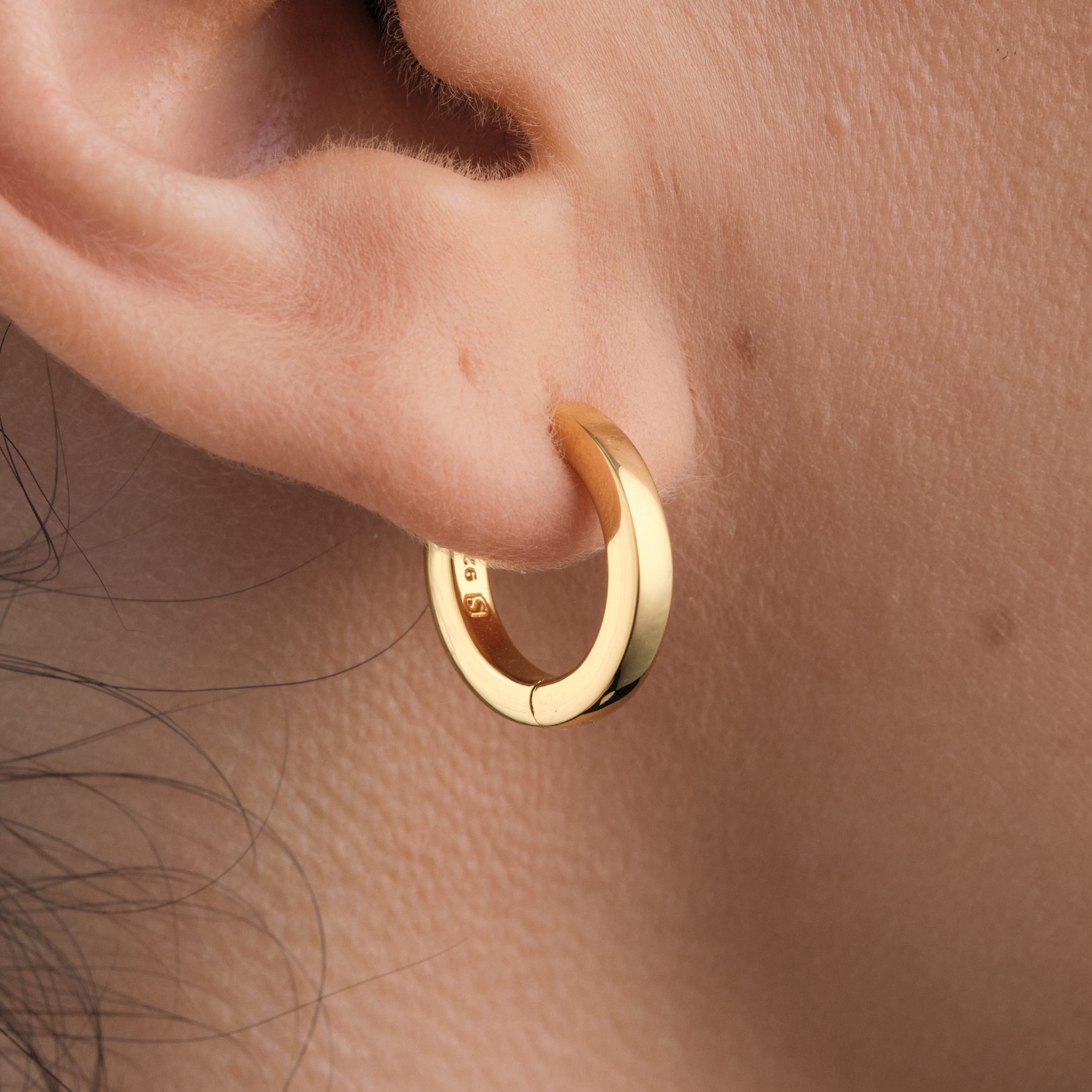 Minimalist 18K gold vermeil huggie hoops. A timeless, tarnish-resistant staple for effortless, everyday elegance.