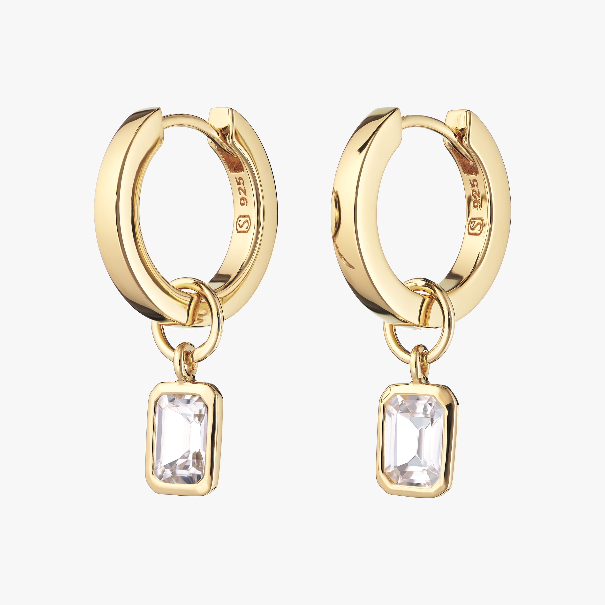 18K gold vermeil huggie hoop earrings with interchangeable white topaz gemstone charms. Affordable luxury with the durability of gold vermeil, these sparkling white topaz earrings are perfect for customisation and everyday elegance.