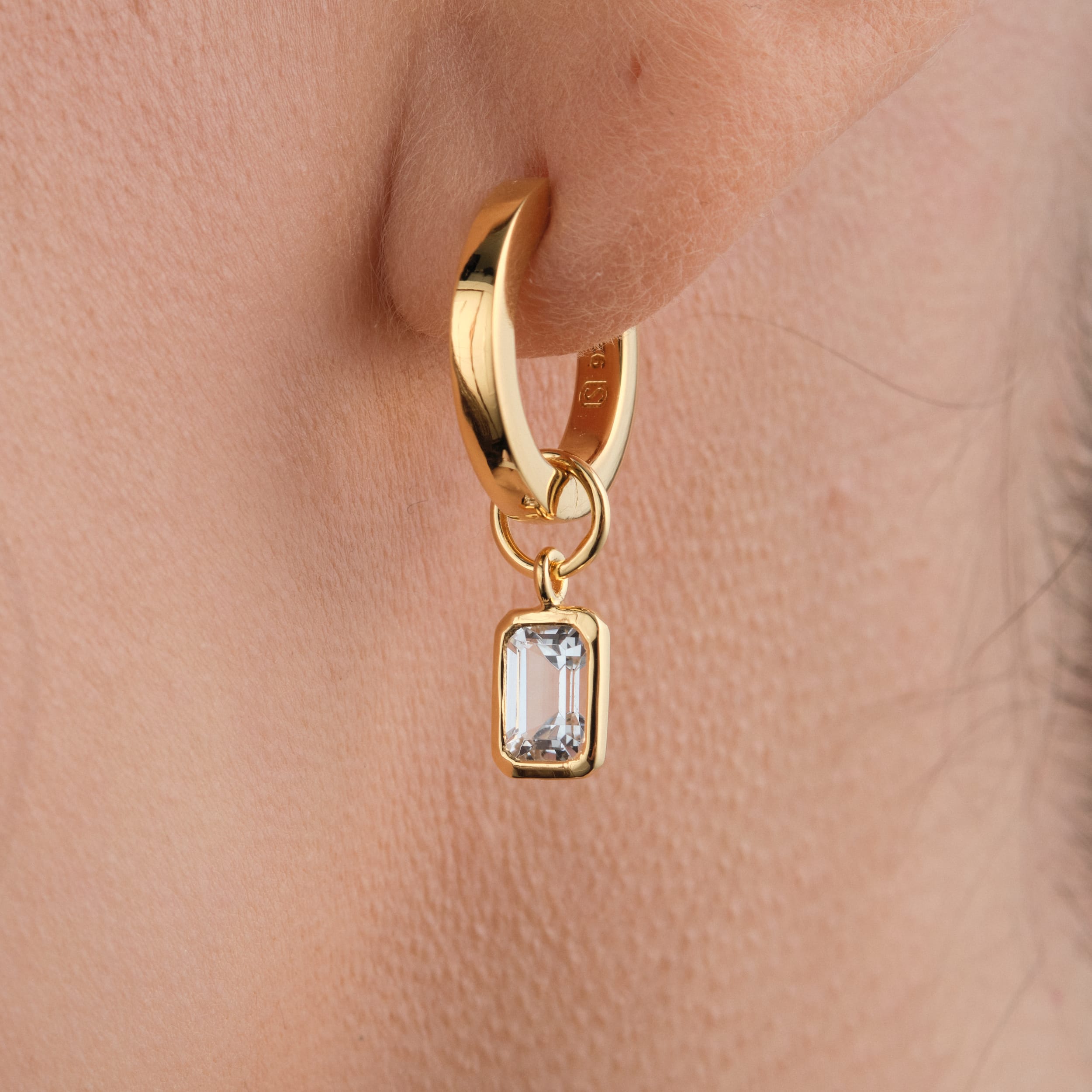 White Topaz Huggie Set in 18k Gold Vermeil - Beautiful White Topaz Earrings on the ear close up.